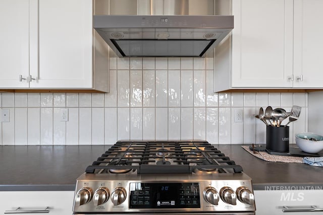 kitchen featuring stove, white cabinetry, and decorative backsplash