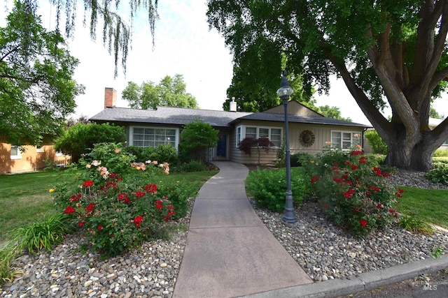 123 15th Ave, Lewiston, ID 83501 - ranch-style house featuring a chimney, a front lawn, and board and batten siding