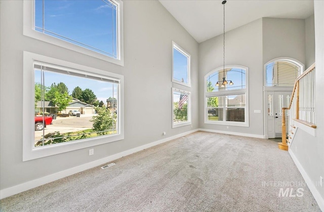 10539 W Merab Ct, Star, ID 83669 - unfurnished living room with a high ceiling, carpet, a chandelier, and stairway