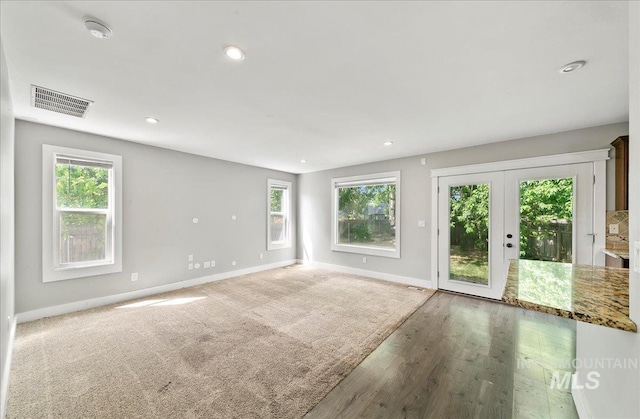 10539 W Merab Ct, Star, ID 83669 - spare room with healthy amount of natural light, a smoke detector, recessed lighting, wood finished floors, and french doors