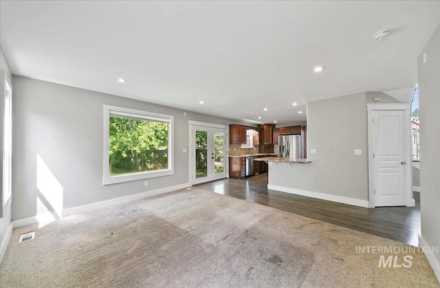 10539 W Merab Ct, Star, ID 83669 - unfurnished living room with dark carpet, recessed lighting, and dark wood-type flooring
