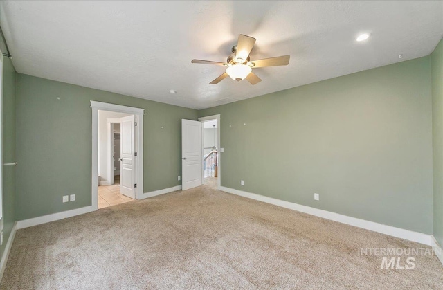 10539 W Merab Ct, Star, ID 83669 - unfurnished bedroom with light colored carpet, connected bathroom, and ceiling fan