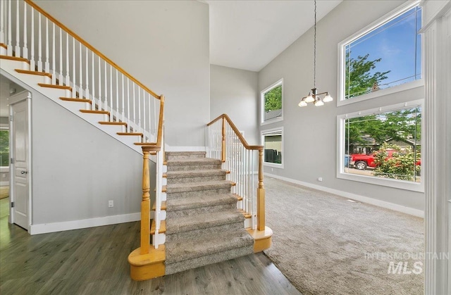 10539 W Merab Ct, Star, ID 83669 - staircase featuring a high ceiling, a chandelier, and wood finished floors