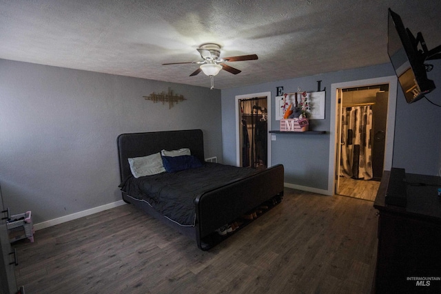 bedroom with ceiling fan, a textured ceiling, baseboards, and wood finished floors