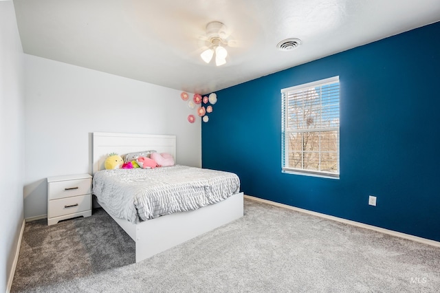 bedroom featuring baseboards, visible vents, carpet floors, and ceiling fan