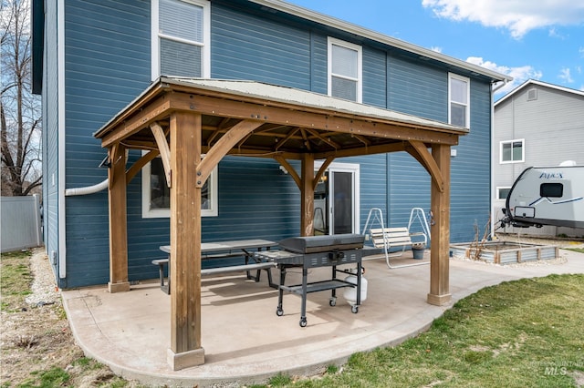 back of property with a gazebo, a patio, and fence