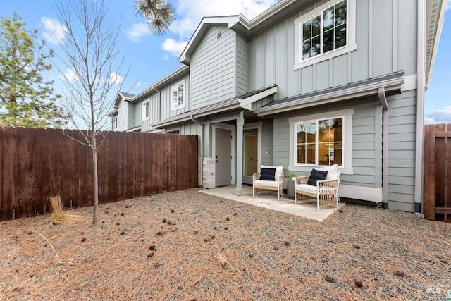 1218 W Ivywild St, Boise, ID 83706 - rear view of house with board and batten siding, a patio, and outdoor lounge area