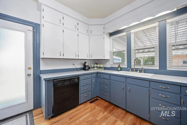 720 E Center St, Kimberly, ID 83341 - kitchen featuring black dishwasher, a sink, light wood finished floors, light countertops, and white cabinets