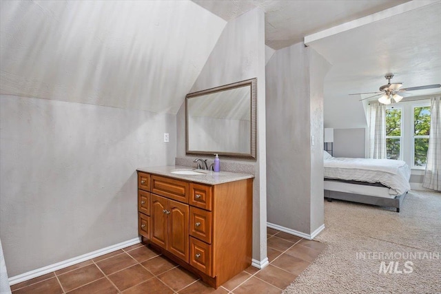 720 E Center St, Kimberly, ID 83341 - ensuite bathroom featuring vanity, tile patterned floors, a ceiling fan, baseboards, and lofted ceiling