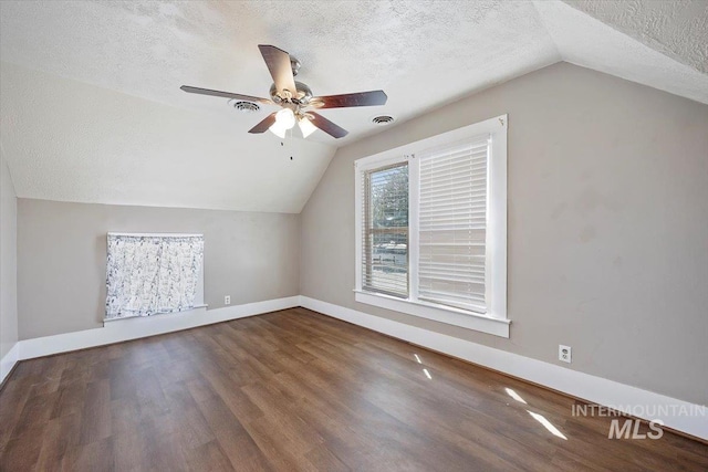 720 E Center St, Kimberly, ID 83341 - bonus room featuring a textured ceiling, lofted ceiling, wood finished floors, baseboards, and ceiling fan