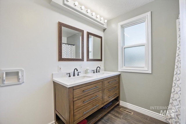 720 E Center St, Kimberly, ID 83341 - full bathroom with double vanity, baseboards, and wood finished floors