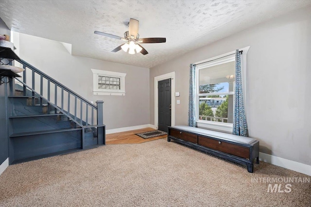 720 E Center St, Kimberly, ID 83341 - entrance foyer featuring carpet floors, a textured ceiling, stairway, and baseboards