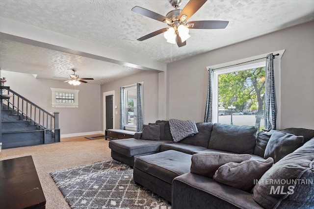 720 E Center St, Kimberly, ID 83341 - living room featuring a ceiling fan, a textured ceiling, stairway, carpet, and baseboards