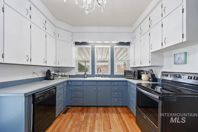 720 E Center St, Kimberly, ID 83341 - kitchen with stainless steel appliances, a sink, white cabinets, light wood-type flooring, and light countertops