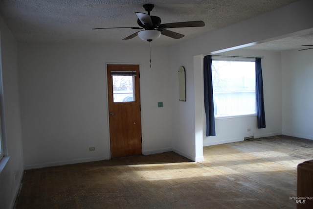 entryway featuring a textured ceiling and ceiling fan