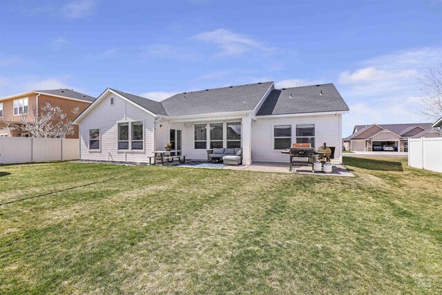back of property featuring an outdoor living space, fence, a patio, and a lawn