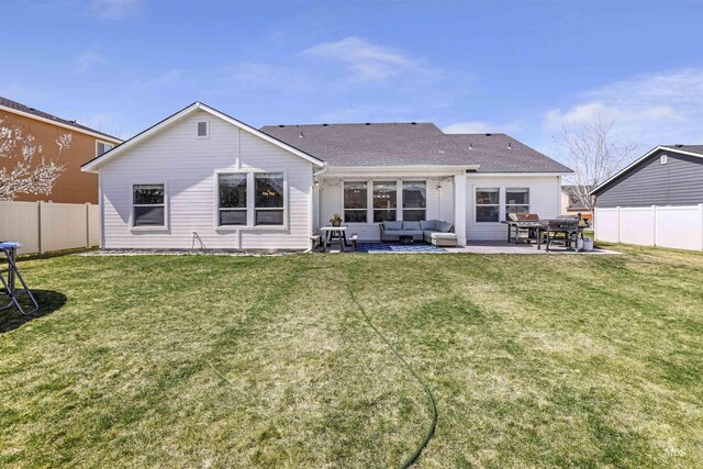 rear view of house with a patio area, a fenced backyard, a lawn, and an outdoor hangout area