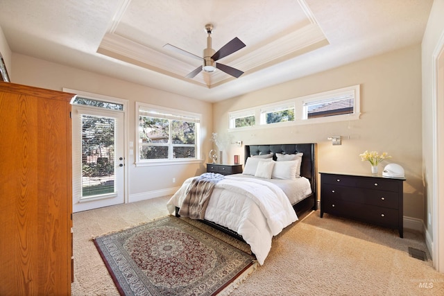 bedroom with crown molding, baseboards, light carpet, a raised ceiling, and access to outside