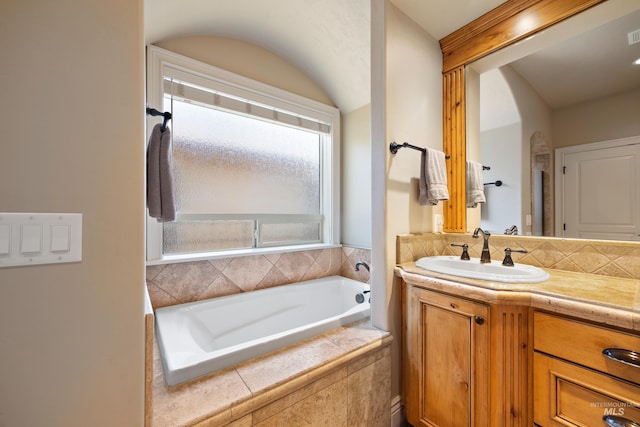 full bath with a bath, visible vents, vanity, and decorative backsplash