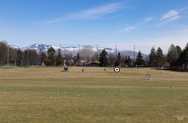 view of home's community with a mountain view and a yard