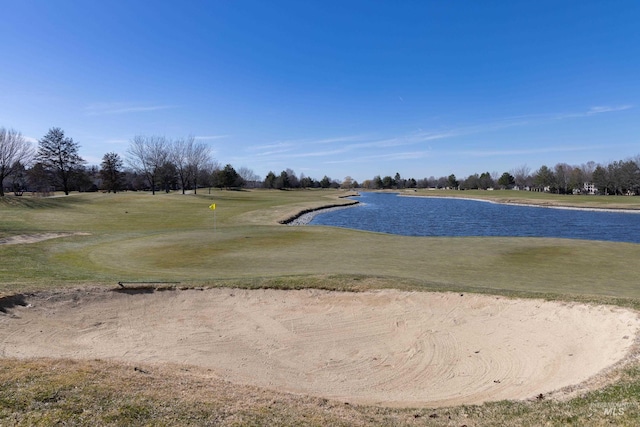 surrounding community with a yard and a water view