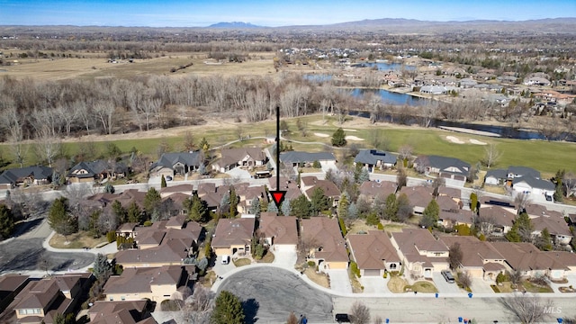 aerial view featuring a residential view, a water and mountain view, and golf course view