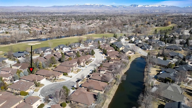 drone / aerial view featuring a residential view and a water and mountain view