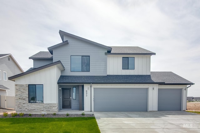 view of front of home with a front lawn and a garage