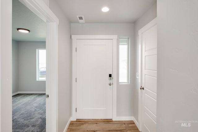 entryway featuring carpet flooring