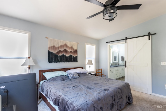 4023 N Bayou Ln, Boise, ID 83703 - bedroom with a barn door, carpet flooring, vaulted ceiling, ensuite bathroom, and baseboards