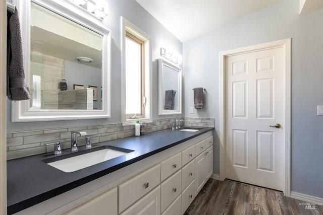 4023 N Bayou Ln, Boise, ID 83703 - bathroom featuring decorative backsplash, wood finished floors, baseboards, and double vanity