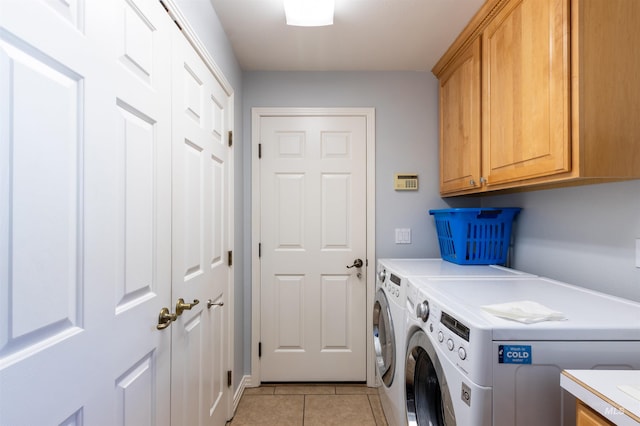 4023 N Bayou Ln, Boise, ID 83703 - clothes washing area featuring cabinet space, washing machine and clothes dryer, and light tile patterned floors