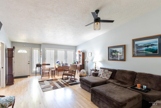 4023 N Bayou Ln, Boise, ID 83703 - living room with light wood-style floors, a textured ceiling, a ceiling fan, and vaulted ceiling