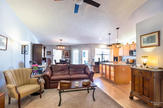 4023 N Bayou Ln, Boise, ID 83703 - living area with ceiling fan, light wood-style flooring, and a textured ceiling