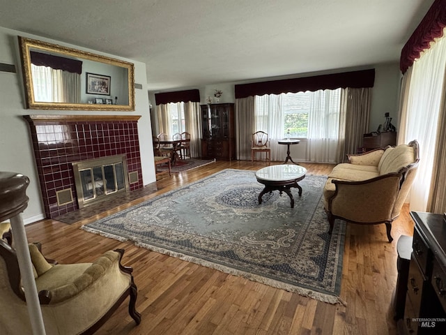 7119 W Everett, Boise, ID 83704 - living area featuring plenty of natural light, wood finished floors, and a fireplace