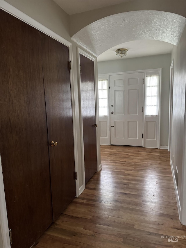 7119 W Everett, Boise, ID 83704 - foyer entrance featuring arched walkways, wood finished floors, and baseboards