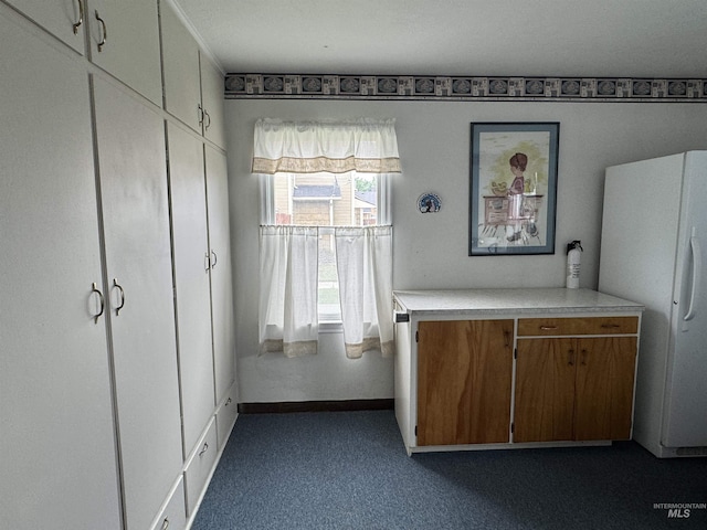 7119 W Everett, Boise, ID 83704 - kitchen with freestanding refrigerator, light countertops, brown cabinetry, dark carpet, and baseboards