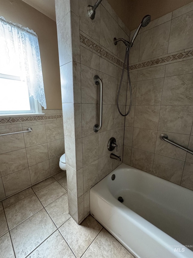 7119 W Everett, Boise, ID 83704 - bathroom featuring tile walls, tile patterned flooring, toilet, bathing tub / shower combination, and wainscoting