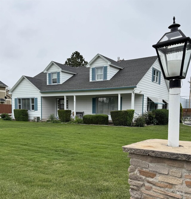 7119 W Everett, Boise, ID 83704 - view of front of home featuring a front yard, a porch, and a shingled roof