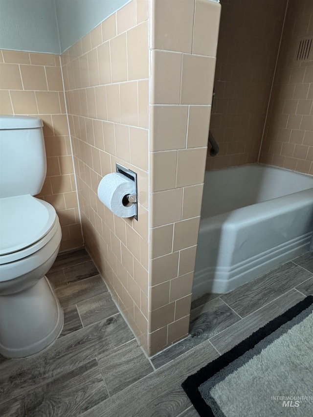7119 W Everett, Boise, ID 83704 - bathroom with toilet, tile walls, and a bathtub