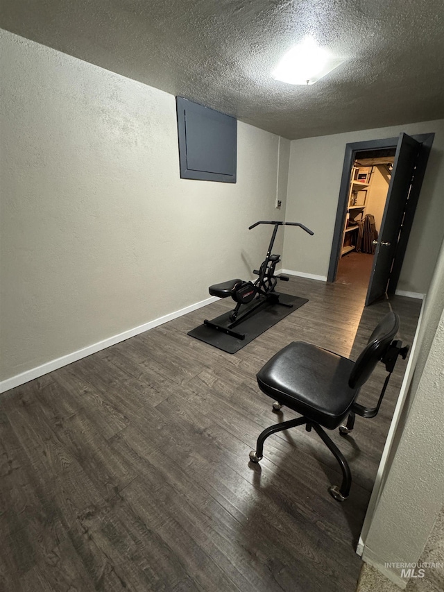 7119 W Everett, Boise, ID 83704 - workout room featuring wood finished floors, a textured ceiling, electric panel, baseboards, and a textured wall