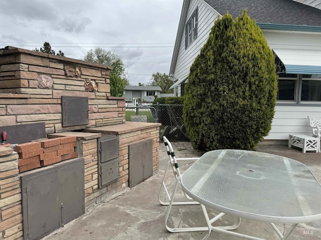7119 W Everett, Boise, ID 83704 - view of patio with an outdoor kitchen, fence, and outdoor dining space