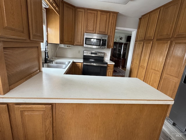 7119 W Everett, Boise, ID 83704 - kitchen featuring stainless steel appliances, a sink, light countertops, and brown cabinetry