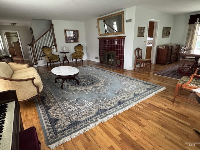 7119 W Everett, Boise, ID 83704 - living area with wood finished floors, a tile fireplace, and stairs