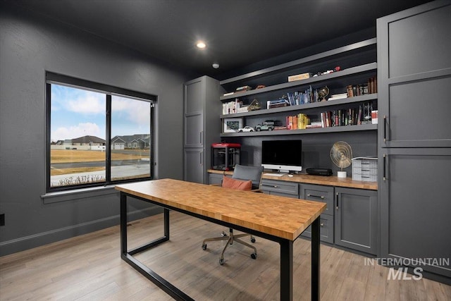 office featuring recessed lighting, baseboards, and light wood-style flooring