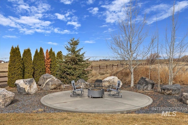 view of patio with a fire pit and fence