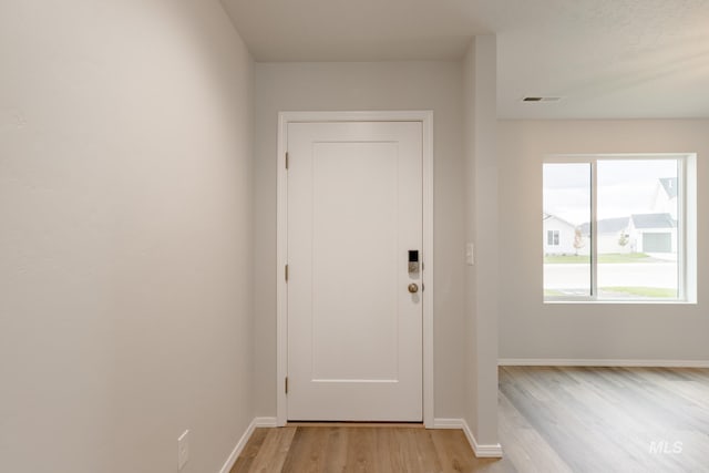 doorway to outside with light hardwood / wood-style flooring