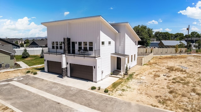 view of front facade featuring a balcony and a garage