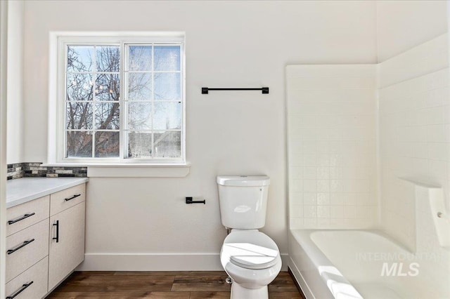 full bathroom with wood-type flooring, a wealth of natural light, vanity, and toilet