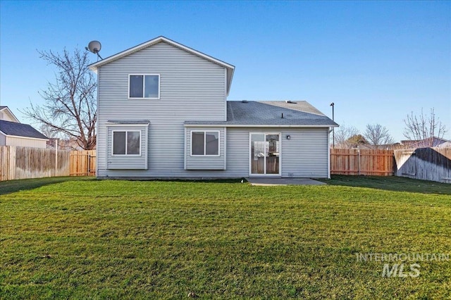 rear view of property with a yard